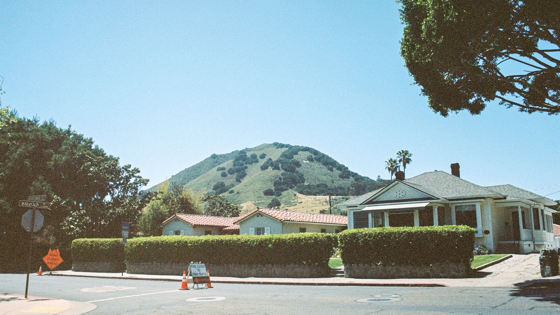 San Luis Obispo neighborhood street with the green hills behind it